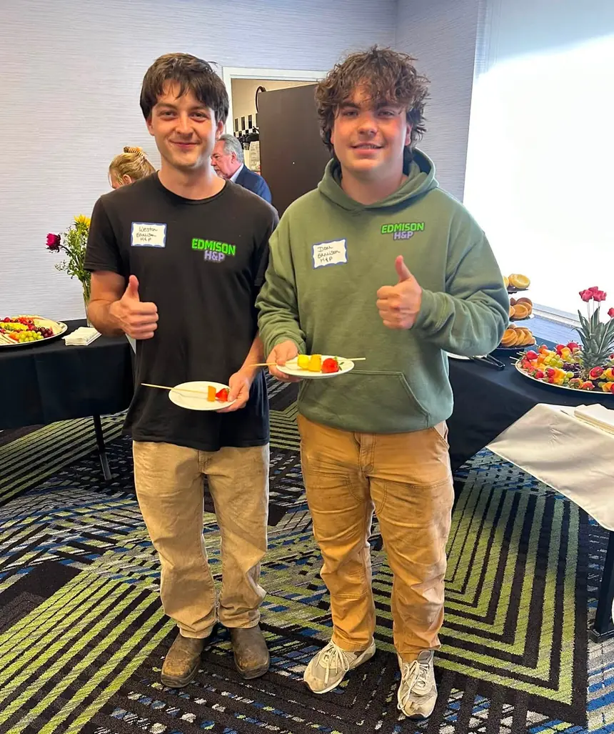 Weston and Dom of EdmisonH&P Property Maintenance in branded crew shirts giving a thumbs up at a North Bay business event