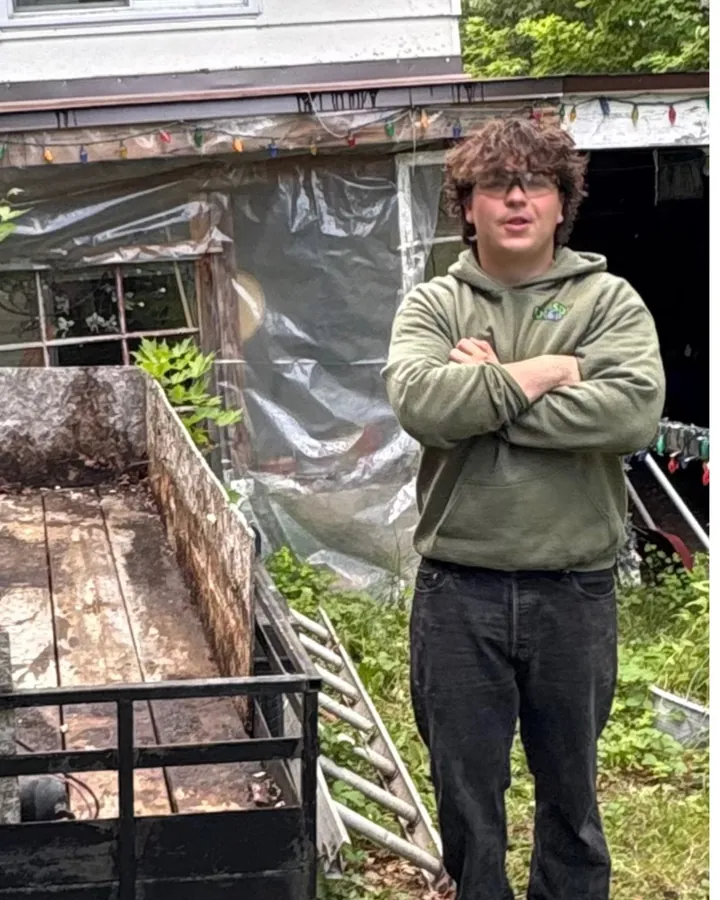 Dominic Edmison, founder of EdmisonH&P Property Maintenance, standing beside the emptied trailer after a North Bay junk removal job