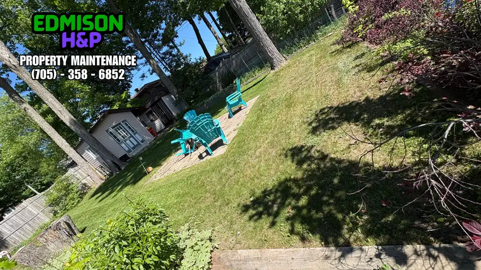Maintained backyard lawn by EdmisonH&P in North Bay with shed and seating area